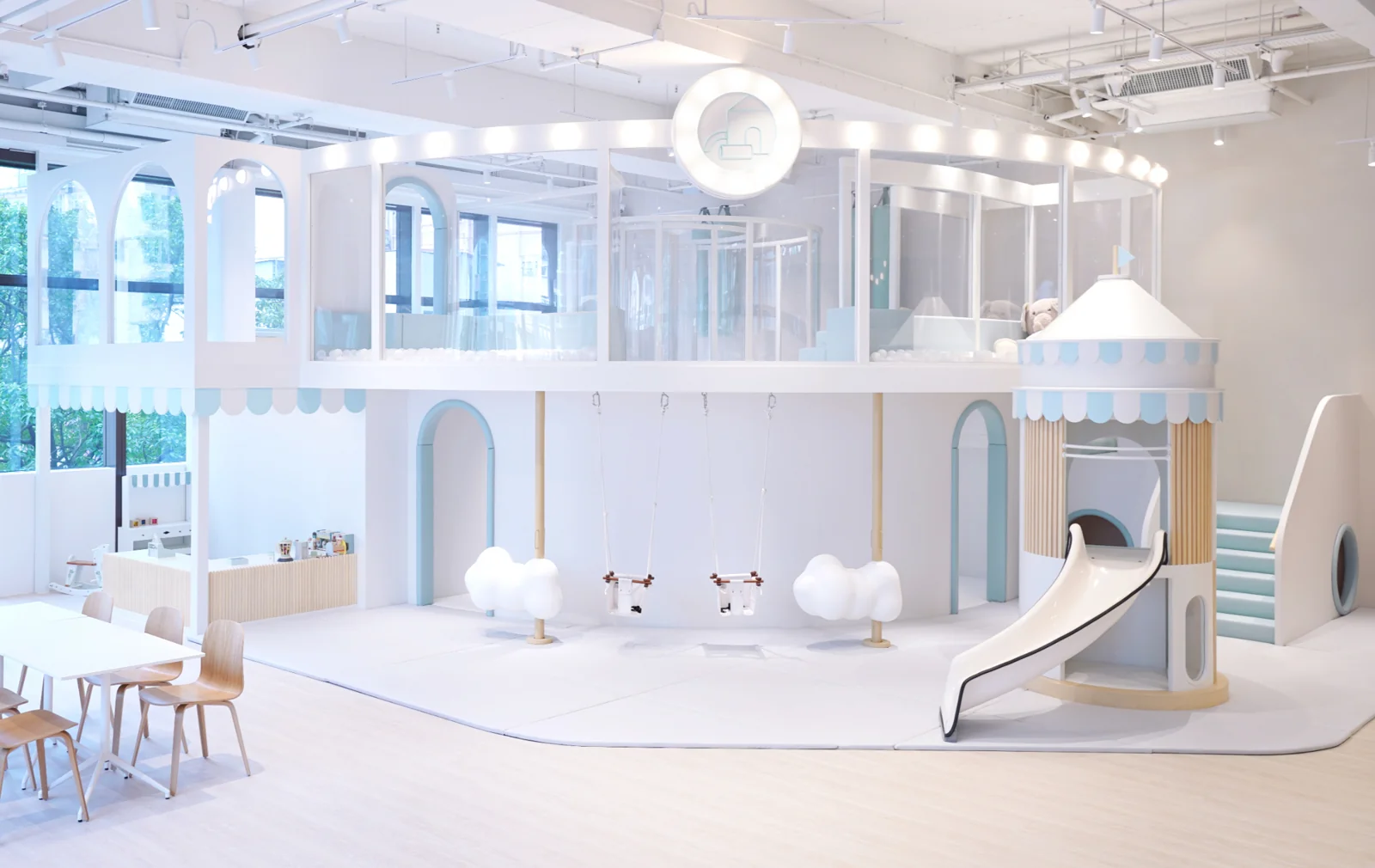 Family Café at Hopewell: pale blue playhouses, swings and slides beside the family dining area